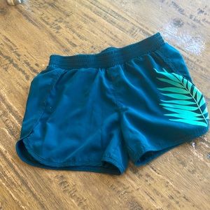 Sea green active wear shorts with leaf design for kids.